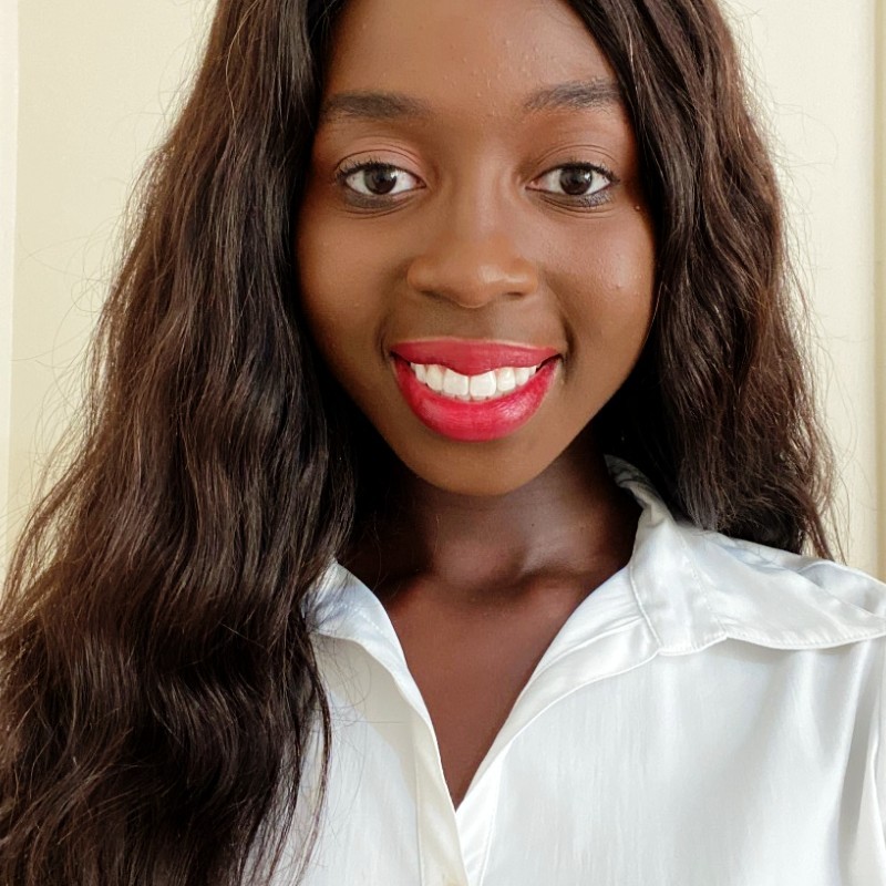 A young black woman wearing a white shirt.